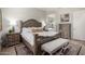Comfortable main bedroom with classic wood furnishings and a view into the primary ensuite bathroom at 2605 S Quaintance St, Gilbert, AZ 85295