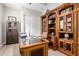 Home office boasting a beautiful wooden desk, bookshelves, and built in cabinets at 2605 S Quaintance St, Gilbert, AZ 85295