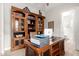 Home office with built in custom wooden cabinets, leather top desk, and natural lighting at 2605 S Quaintance St, Gilbert, AZ 85295
