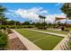 Community park with a green bocce ball court, walking trails, playgrounds, and seating for residents' enjoyment at 2605 S Quaintance St, Gilbert, AZ 85295