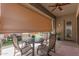 Inviting outdoor patio with comfortable seating and retractable sunshade, perfect for relaxing or entertaining guests at 2605 S Quaintance St, Gilbert, AZ 85295