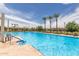 Community pool featuring ample seating areas, and palm trees, perfect for residents to relax, swim, and socialize at 2605 S Quaintance St, Gilbert, AZ 85295