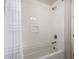 Shower-tub combination with white tiled walls, brushed nickel fixtures, and a shower curtain at 2605 S Quaintance St, Gilbert, AZ 85295