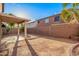 Spacious backyard featuring a covered patio, block wall, and plenty of room for outdoor activities and landscaping at 2652 E Riviera Dr, Chandler, AZ 85249