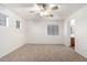 Bright bedroom boasts neutral carpet, multiple windows, and a ceiling fan at 2652 E Riviera Dr, Chandler, AZ 85249