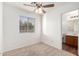 Cozy bedroom with carpeted flooring, ceiling fan and a window providing natural light at 2652 E Riviera Dr, Chandler, AZ 85249