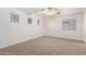 Spacious carpeted bedroom with ceiling fan and multiple windows at 2652 E Riviera Dr, Chandler, AZ 85249