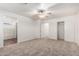 Large carpeted bedroom with ceiling fan, walk-in closet and access to bathroom at 2652 E Riviera Dr, Chandler, AZ 85249