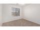 Bedroom with carpeted flooring and a window providing natural light at 2652 E Riviera Dr, Chandler, AZ 85249