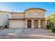 Inviting home with an arched entryway, two-car garage, and a tiled roof at 2652 E Riviera Dr, Chandler, AZ 85249