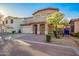 Well-maintained home showcasing a front yard tree and a paved driveway at 2652 E Riviera Dr, Chandler, AZ 85249