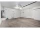 Large garage with a concrete floor, water heater, interior door, and plenty of space for storage or a workshop at 2652 E Riviera Dr, Chandler, AZ 85249