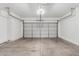 Spacious two car garage featuring a clean, concrete floor, automatic door and ample space for parking and storage at 2652 E Riviera Dr, Chandler, AZ 85249