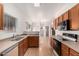 Kitchen boasts wood cabinets, stainless steel dishwasher, and wood-look floors with an open concept at 2652 E Riviera Dr, Chandler, AZ 85249