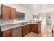 Kitchen boasts wood cabinets, stainless steel dishwasher, and wood-look floors at 2652 E Riviera Dr, Chandler, AZ 85249