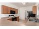 Well-lit kitchen features wood cabinets, black appliances, laminate counters, and wood-look flooring at 2652 E Riviera Dr, Chandler, AZ 85249