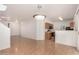 Bright living space with an open view of the kitchen, hardwood floors, and access to the front entrance at 2652 E Riviera Dr, Chandler, AZ 85249