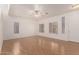 Open-concept living room featuring hardwood floors, white walls, and natural light at 2652 E Riviera Dr, Chandler, AZ 85249