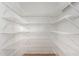 Spacious pantry features new white metal shelving and wood-look flooring at 2652 E Riviera Dr, Chandler, AZ 85249
