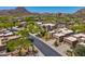 Aerial view of homes in a planned community surrounded by desert landscape and mountains at 27892 N 108Th Way, Scottsdale, AZ 85262