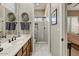 Bathroom featuring modern vanity, decorative accents, and a glass-enclosed walk-in shower at 27892 N 108Th Way, Scottsdale, AZ 85262