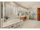 Luxurious bathroom featuring a soaking tub, marble accents, and a glass-enclosed shower at 27892 N 108Th Way, Scottsdale, AZ 85262