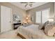 Comfortable bedroom with a ceiling fan, plantation shutters, and contemporary decor at 27892 N 108Th Way, Scottsdale, AZ 85262