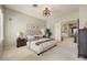Tranquil bedroom featuring a tufted headboard, soft lighting, and a view to the hallway at 27892 N 108Th Way, Scottsdale, AZ 85262