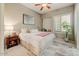 Comfortable bedroom with soft decor, a ceiling fan, and natural light from the window at 27892 N 108Th Way, Scottsdale, AZ 85262