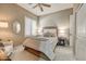 Bedroom with neutral walls, a ceiling fan, plantation shutters, and modern decor at 27892 N 108Th Way, Scottsdale, AZ 85262