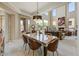 Elegant dining room with decorative lighting fixture and access to the adjacent living area at 27892 N 108Th Way, Scottsdale, AZ 85262