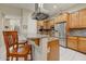 Eat-in kitchen shows a breakfast bar, stainless steel appliances, granite countertops, and wood cabinets at 27892 N 108Th Way, Scottsdale, AZ 85262
