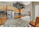 Updated kitchen features stainless steel appliances, granite countertops, wooden cabinetry, and tile backsplash at 27892 N 108Th Way, Scottsdale, AZ 85262