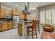 Kitchen boasts granite countertops, stainless appliances, and wooden cabinetry, flowing into a seating area at 27892 N 108Th Way, Scottsdale, AZ 85262