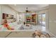 Bright living room features a fireplace with stone surround, ceiling fan, white sectional sofa, and sliding door access to the outdoors at 27892 N 108Th Way, Scottsdale, AZ 85262