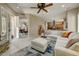 Open-concept living room with tile floors, white sectional sofa, view of kitchen, dining room and staircase at 27892 N 108Th Way, Scottsdale, AZ 85262
