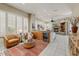 Spacious living room with a built-in wet bar, fireplace, plantation shutters, and tile flooring at 27892 N 108Th Way, Scottsdale, AZ 85262