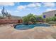 Backyard pool and spa surrounded by desert landscaping, stone walkways, and a decorative wall at 27892 N 108Th Way, Scottsdale, AZ 85262