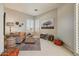Cozy sitting room with comfortable seating, plantation shutters, and an artistic accent wall at 27892 N 108Th Way, Scottsdale, AZ 85262