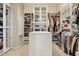 Organized walk-in closet with custom shelving, hanging space, and a central island at 27892 N 108Th Way, Scottsdale, AZ 85262