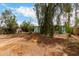 Spacious backyard with mature trees and a barbecue grill, offering a relaxing outdoor space at 2944 W Northern Ave, Phoenix, AZ 85051