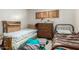Cozy bedroom with two single beds, dresser, and window with shutters, creating a comfortable space at 2944 W Northern Ave, Phoenix, AZ 85051