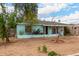 Single-story blue home featuring mature trees and a spacious front yard at 2944 W Northern Ave, Phoenix, AZ 85051