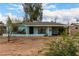 Quaint single-story home with a light blue exterior and covered entrance nestled on a lot with mature trees at 2944 W Northern Ave, Phoenix, AZ 85051