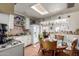 Functional kitchen with a gas range and skylight, offering a cozy dining area, adjacent to the living room at 2944 W Northern Ave, Phoenix, AZ 85051