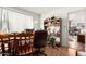 Home office featuring a large desk and shelving, leading to the living room and fireplace beyond at 2944 W Northern Ave, Phoenix, AZ 85051