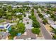 High aerial view displaying residential neighborhood, tree canopy and street layout at 302 E Orange Dr, Phoenix, AZ 85012