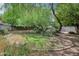 Spacious backyard featuring established landscaping, shade trees, and a serene atmosphere at 302 E Orange Dr, Phoenix, AZ 85012