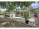 Backyard featuring a concrete patio, drought resistant vegetation and a light grey exterior at 302 E Orange Dr, Phoenix, AZ 85012
