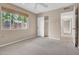 Comfortable bedroom with neutral carpet, a window with blinds, and an closet with an open doorway at 302 E Orange Dr, Phoenix, AZ 85012